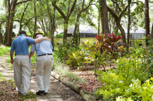 senior walking with caregiver